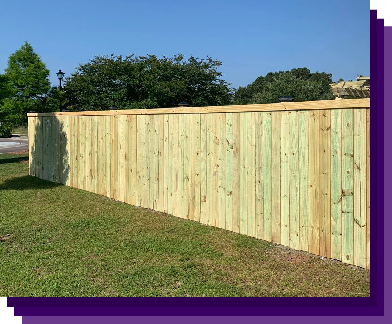 Stately wooden privacy fence surrounding a lush garden